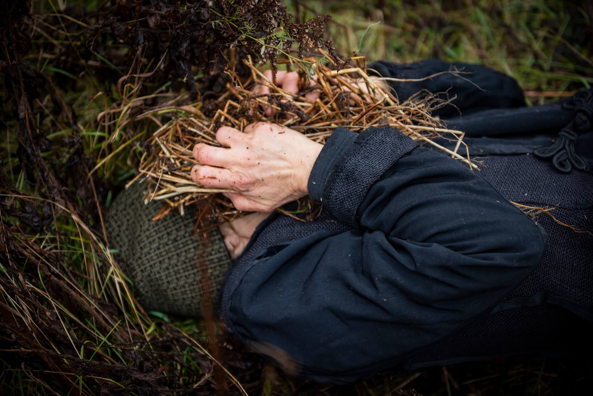 holding straw over face lying down