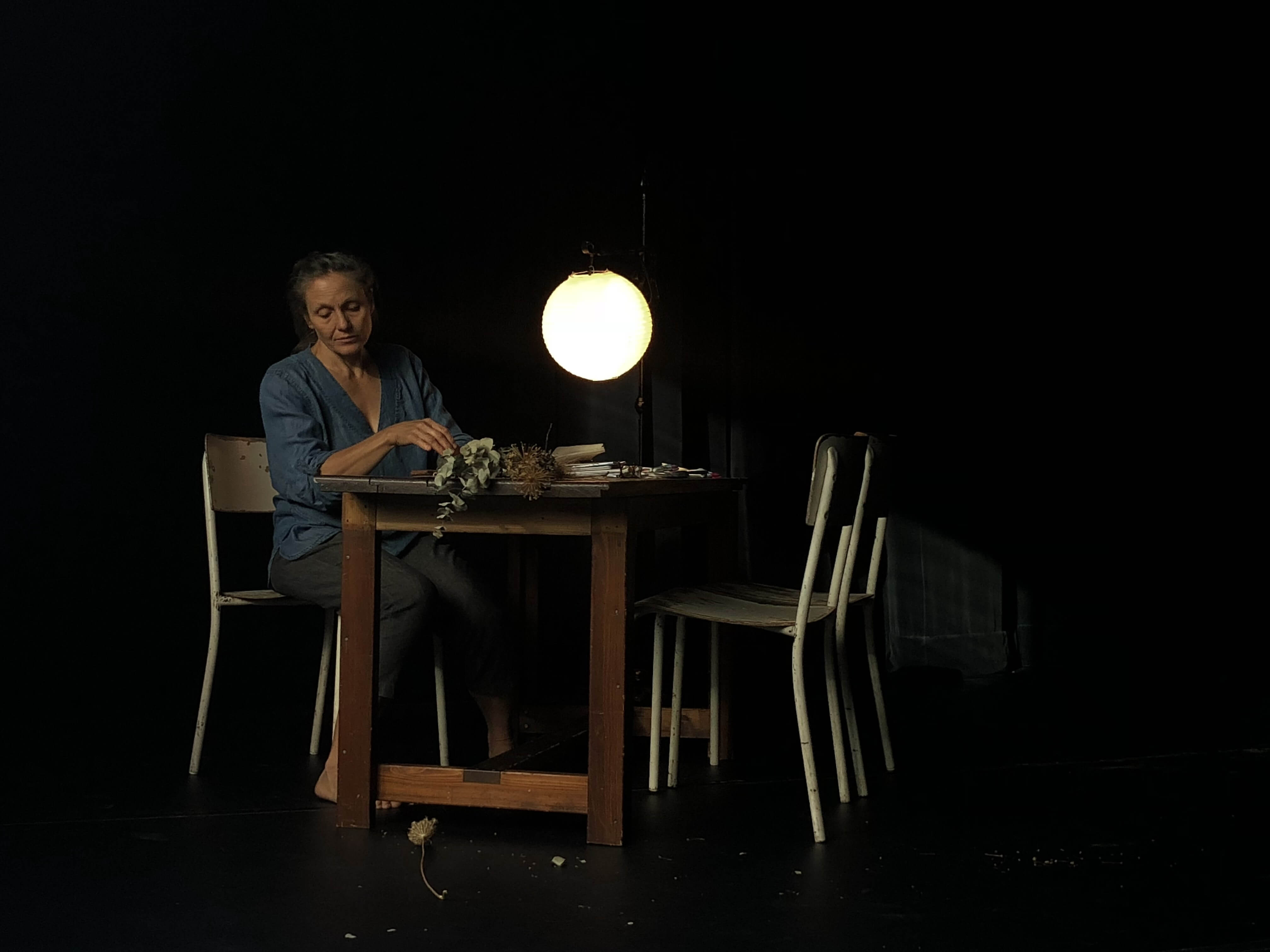 artist at table sitting with moon lamp