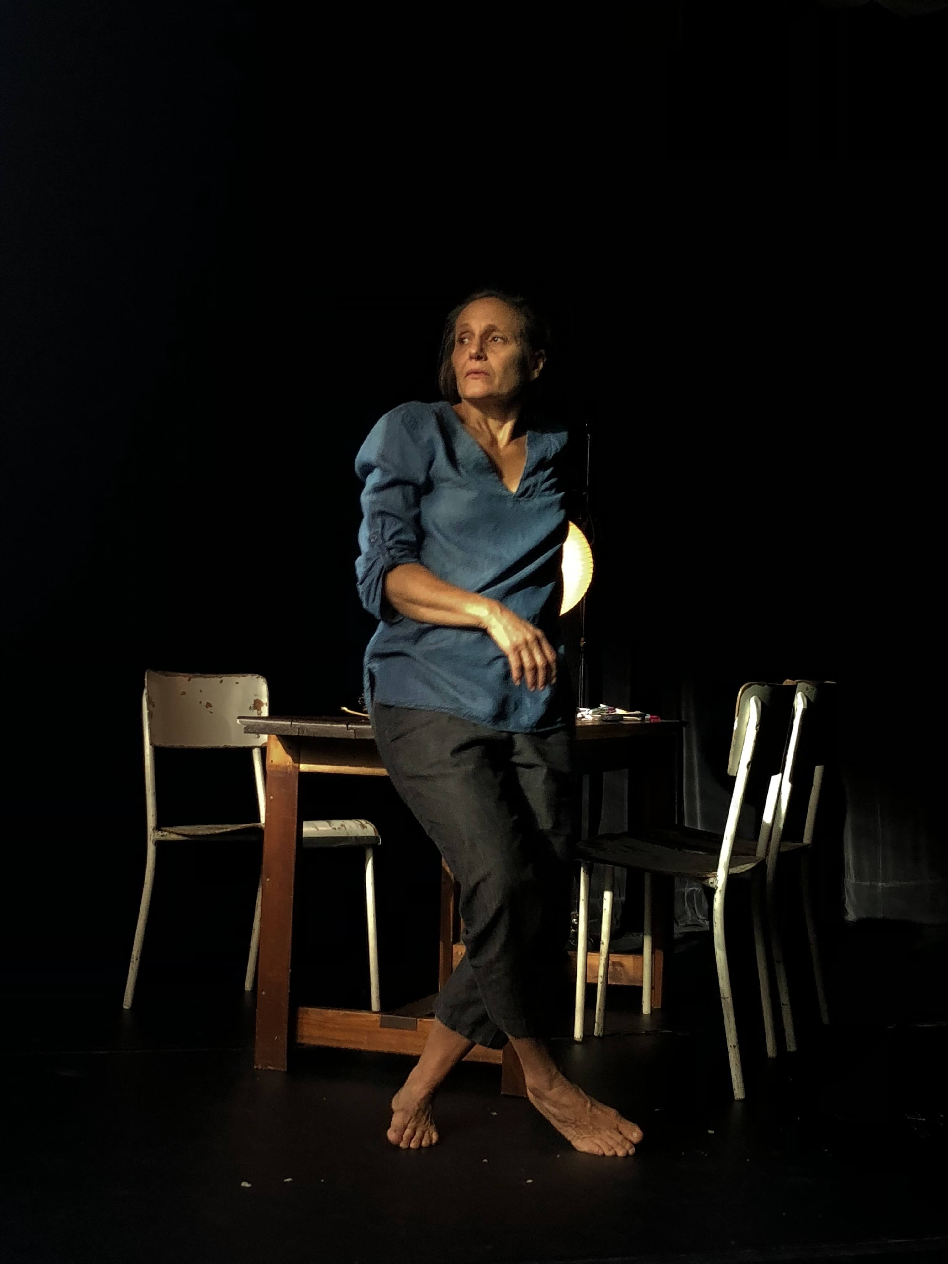 legs crossed standing infront of table